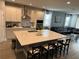 Spacious kitchen with white cabinets, large island, and stainless steel appliances at 14827 Milfoil Ave, Orlando, FL 32827