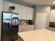 Modern kitchen with stainless steel appliances and white cabinets at 14827 Milfoil Ave, Orlando, FL 32827