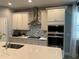 Modern kitchen with stainless steel appliances and white cabinets at 14827 Milfoil Ave, Orlando, FL 32827