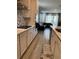 Open concept kitchen with white cabinets and view to living room at 14827 Milfoil Ave, Orlando, FL 32827