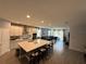 Open concept kitchen with island and seating at 14827 Milfoil Ave, Orlando, FL 32827