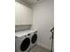 Bright laundry room with LG washer and dryer and white cabinets at 14827 Milfoil Ave, Orlando, FL 32827