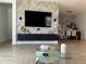 Open living room and dining area with modern decor and large TV at 14827 Milfoil Ave, Orlando, FL 32827