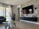 Bright living room features a large TV, stylish wall decor, and ample seating at 14827 Milfoil Ave, Orlando, FL 32827