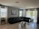 Spacious living room with sectional sofa and large windows at 14827 Milfoil Ave, Orlando, FL 32827