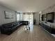 Spacious living room with large sectional sofa and wood-look floors at 14827 Milfoil Ave, Orlando, FL 32827