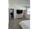 Spacious main bedroom with large TV, dresser, and access to other rooms at 14827 Milfoil Ave, Orlando, FL 32827