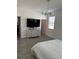 Spacious main bedroom with large TV, dresser, and access to other rooms at 14827 Milfoil Ave, Orlando, FL 32827