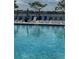 Community pool with lounge chairs and umbrellas at 14827 Milfoil Ave, Orlando, FL 32827
