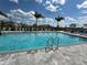 Inviting community pool with palm trees at 14827 Milfoil Ave, Orlando, FL 32827