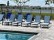 Blue lounge chairs by the community pool at 14827 Milfoil Ave, Orlando, FL 32827