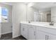 Bright bathroom featuring double sinks, a large mirror, and modern fixtures at 211 Bull Frog Ln, Umatilla, FL 32784