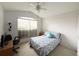Bright bedroom with double bed, window, and ceiling fan at 2511 La Jolla Trl, Kissimmee, FL 34747