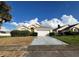 Cute yellow house with a two-car garage and well-manicured lawn at 2511 La Jolla Trl, Kissimmee, FL 34747