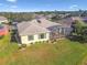 Aerial view of a house with a screened lanai and a well-maintained lawn at 256 New River Dr, Poinciana, FL 34759