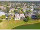 Aerial view of a home with a screened lanai located on a lake at 256 New River Dr, Poinciana, FL 34759