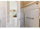 Bright bathroom features a glass door shower and view into the rest of the home at 256 New River Dr, Poinciana, FL 34759