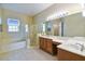 Spacious bathroom with double vanities, shower, soaking tub, and ample counter space at 256 New River Dr, Poinciana, FL 34759
