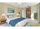Neutral bedroom featuring a large window, cool color accents, and a walk in closet at 256 New River Dr, Poinciana, FL 34759