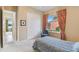 Comfortable bedroom with a closet, a view of the outdoors, and serene decorations at 256 New River Dr, Poinciana, FL 34759