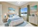 Inviting bedroom with a king bed, neutral walls, and large windows overlooking the lake at 256 New River Dr, Poinciana, FL 34759