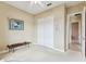 Bedroom with neutral walls and white trim with view of garden area through a large window at 256 New River Dr, Poinciana, FL 34759