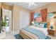 Cozy bedroom with bright decorations, closet, and a large window for natural light at 256 New River Dr, Poinciana, FL 34759