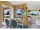 Charming dining area with seating for four and sliding door access to a screened porch with beautiful water views at 256 New River Dr, Poinciana, FL 34759