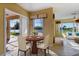 Cozy dining area with patio access and stunning views of the lake and screened lanai at 256 New River Dr, Poinciana, FL 34759