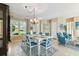 The dining room has large windows and an adjacent sitting area offering great space and decor at 256 New River Dr, Poinciana, FL 34759