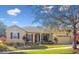 Charming single-story home with a two-car garage, well-maintained lawn, and mature landscaping at 256 New River Dr, Poinciana, FL 34759
