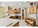 A spacious kitchen features stone countertops, wooden cabinets, and modern stainless steel appliances at 256 New River Dr, Poinciana, FL 34759