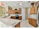 Bright eat-in kitchen featuring tile floors, stainless appliances, light wood cabinets, and white countertops at 256 New River Dr, Poinciana, FL 34759