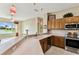 Open kitchen boasts lots of counter space and stainless steel appliances with a view to the lake at 256 New River Dr, Poinciana, FL 34759