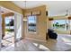 Open concept living area offers a view of the lake and includes tile floors and comfortable furniture at 256 New River Dr, Poinciana, FL 34759