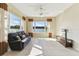 Comfortable living room featuring tile floors, decorative curtains, and panoramic views of the lake at 256 New River Dr, Poinciana, FL 34759