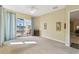 Bright living room with neutral carpet and a sliding glass door offering water views and access to the outdoors at 256 New River Dr, Poinciana, FL 34759