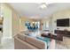 Bright and airy living room is perfect for entertaining with modern decor and accents at 256 New River Dr, Poinciana, FL 34759
