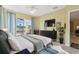 Serene bedroom with water views from sliding glass doors, plus a modern dresser and decor at 256 New River Dr, Poinciana, FL 34759