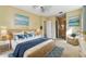 Comfortable main bedroom with wicker furniture, a ceiling fan, and views of the water at 256 New River Dr, Poinciana, FL 34759