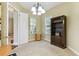 Office with carpet and built-in bookcase, and a chandelier in the center of the room at 256 New River Dr, Poinciana, FL 34759