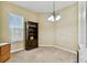 Bright office space with a bookshelf and a large window letting in natural light at 256 New River Dr, Poinciana, FL 34759