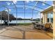 Screened-in patio overlooking the lake provides ample seating and picturesque water views at 256 New River Dr, Poinciana, FL 34759
