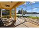 Screened-in patio with seating, showcasing water view and outdoor living space at 256 New River Dr, Poinciana, FL 34759