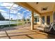 Relaxing screened patio with lake view and lounge chairs at 256 New River Dr, Poinciana, FL 34759