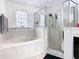 Clean bathroom with a bathtub, shower, and updated fixtures at 269 Beckenham Dr, Kissimmee, FL 34758