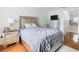 Bright bedroom with a double bed, dresser and wood floors at 269 Beckenham Dr, Kissimmee, FL 34758