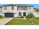 Two-story house with white walls, dark gray garage door, and manicured lawn at 269 Beckenham Dr, Kissimmee, FL 34758