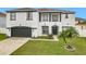 Two-story house with white exterior, black accents, and a two-car garage at 269 Beckenham Dr, Kissimmee, FL 34758