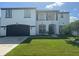 Two-story house with white exterior, black accents, and a two-car garage at 269 Beckenham Dr, Kissimmee, FL 34758